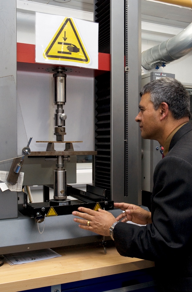Dr Hom Nath Dhakal with a three point bend testing machine